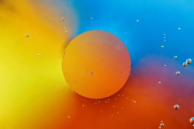 Abstract image of orange circle on multicoloured...
