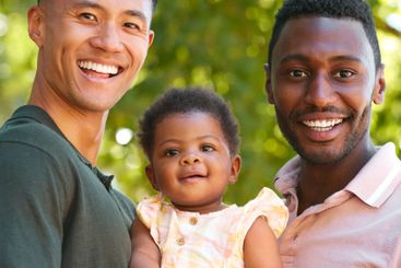 Portrait Of Same Sex Male Couple Or Friends Cuddling...