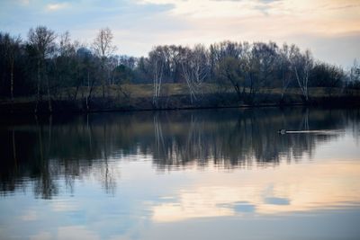 Early spring. Sunset and twilight on the river next to...
