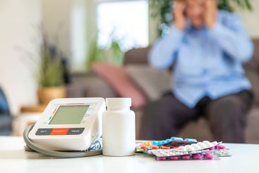 An old woman measures her blood pressure. Selective focus.