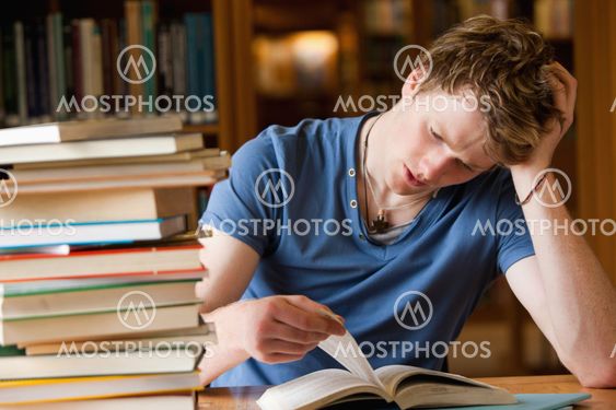 Tired man reading a book