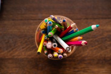Top down view of a cup of colour pencils.