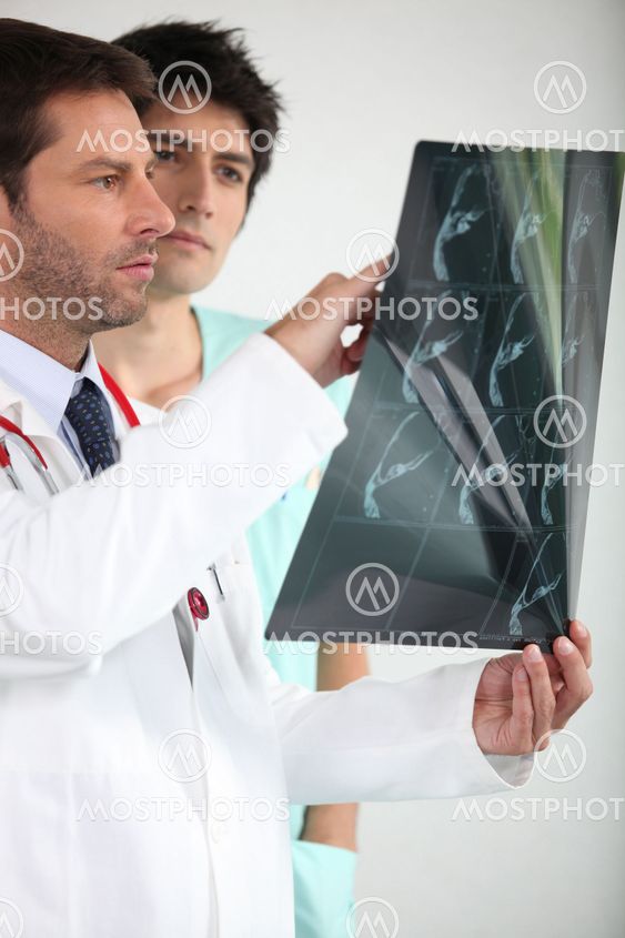 Two doctors looking at x-ray image