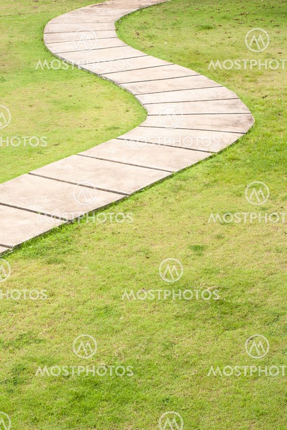 Curved path and green grass background