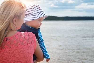 woman and baby at the beach near sea