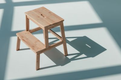simple wooden flower stand at empty room with daylight