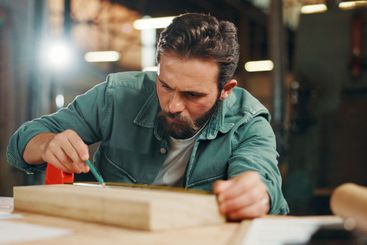 Pencil, carpenter and mark wood to measure for...