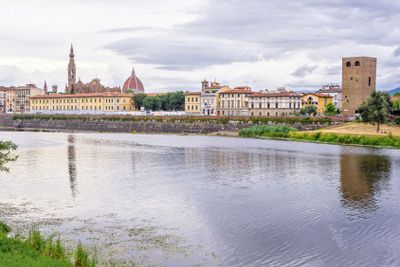Daylight cloudy day view to Arno river with reflections