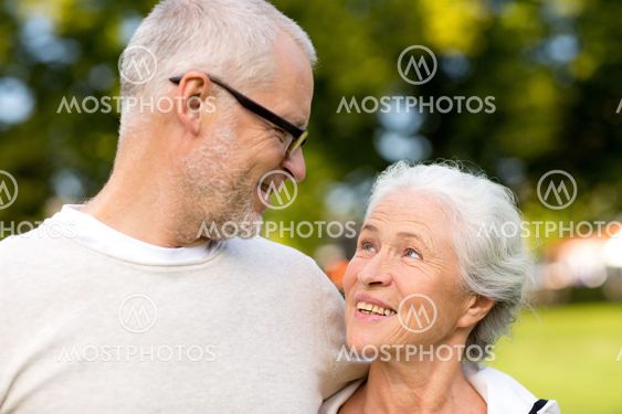 senior couple hugging in city park