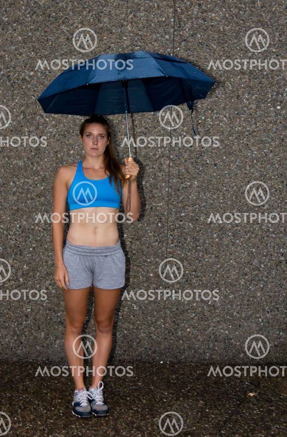 Fit woman holding an umbrella