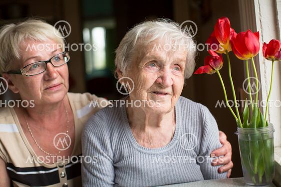 Portrait of an elderly woman with adult daughter.
