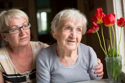 Portrait of an elderly woman with adult daughter.