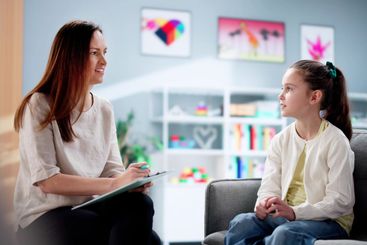 Child Therapist Comforting a Depressed Kid Patient