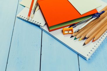 Colorful stationery and supplies arranged on a wooden...