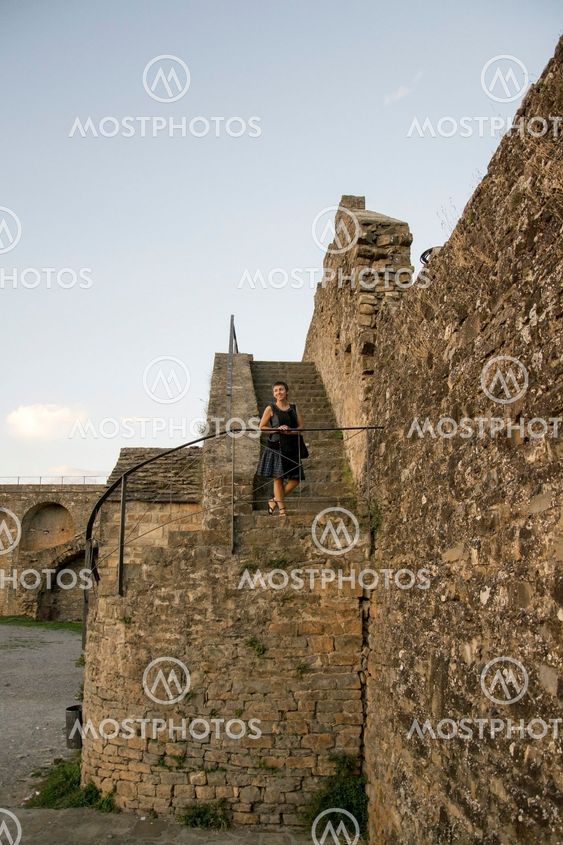 Carol on a stone stair. Lateral look.