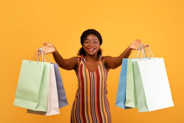 Seasonal sales and shopping. Charming young black woman...