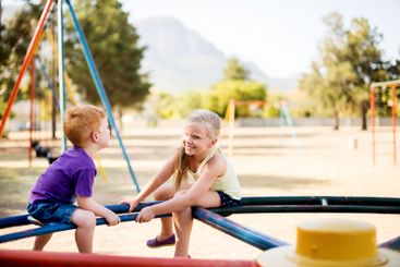 Happy, kids and carousel at playground outdoor for fun...