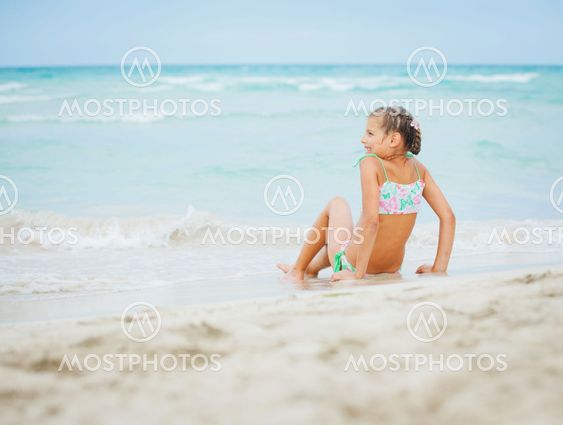 Adorable happy little girl on beach vacation