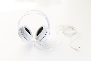 White headphones on white background close up