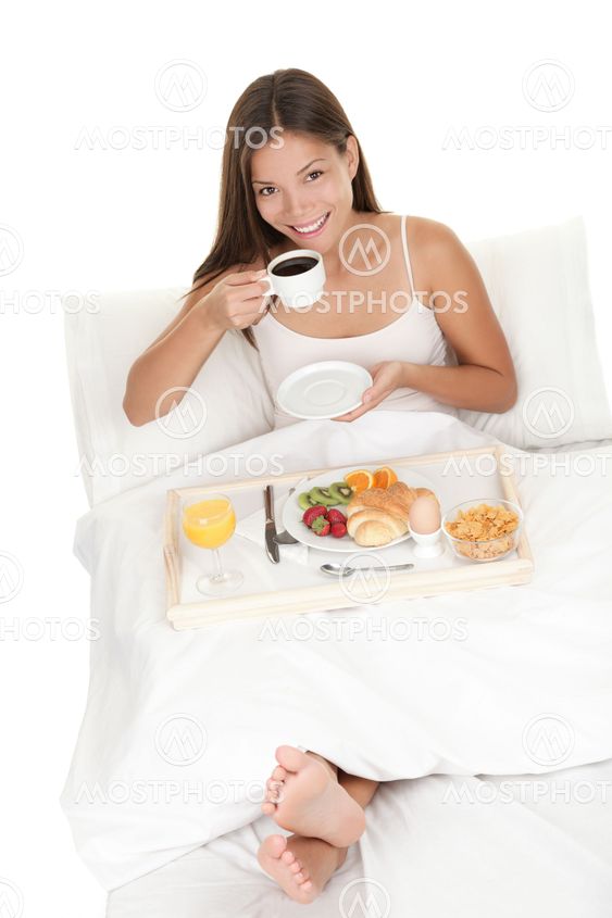 Woman eating breakfast in bed