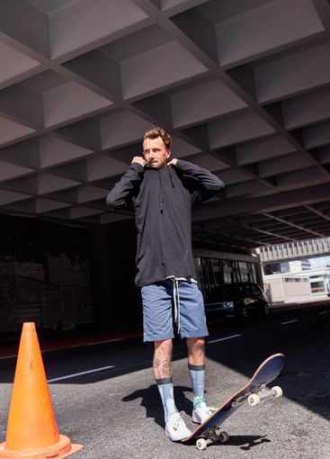 Man, skateboarder and thinking in urban city, street and...