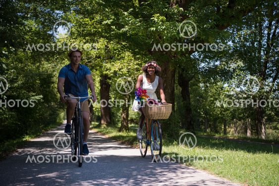 Young multiethnic couple having a bike ride in nature