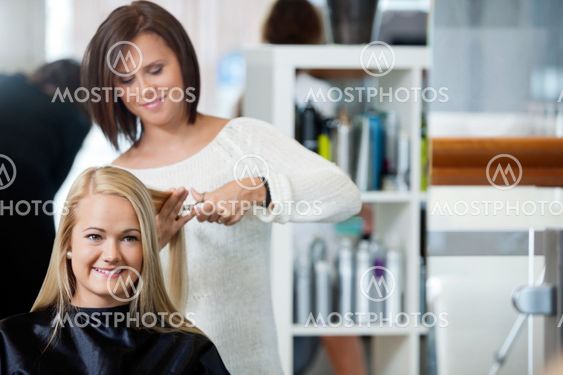 Woman Getting Haircut At Parlor