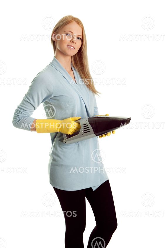 Cheerful woman with handheld vacuum cleaner