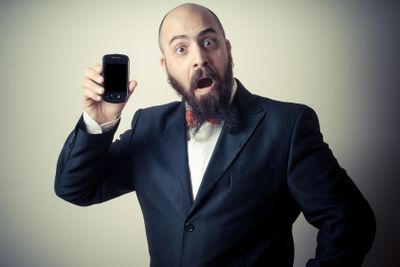  funny elegant bearded man showing phone
