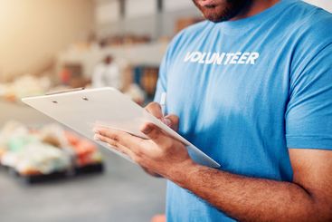 Checklist, man and hands of volunteer writing for...