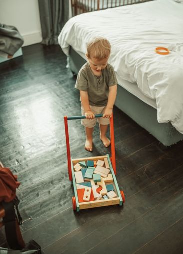 Bedroom, toys and toddler kid playing in his nursery for...