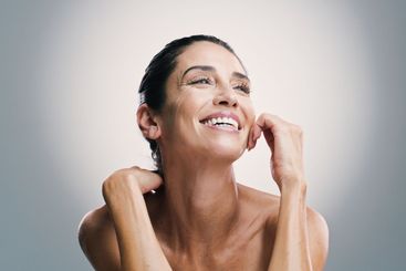 Thinking, woman and smile for skincare in studio of...