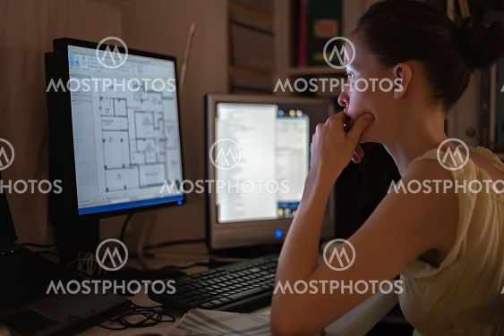 Young woman working at home, remote location, using...