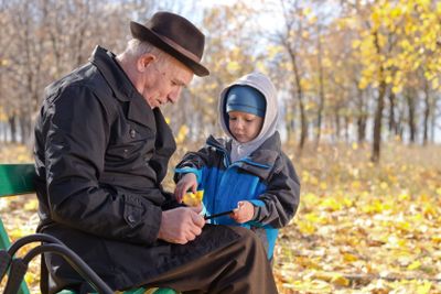 Elderly man with his grandson in the park