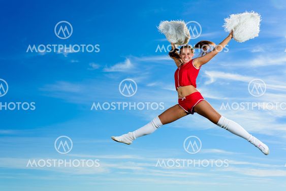 Young cheerleader in red costume jumping