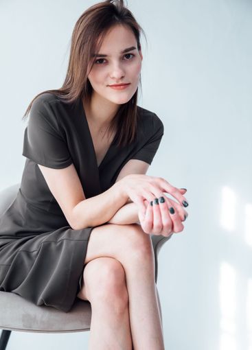 Portrait of a beautiful slender woman in a gray summer...