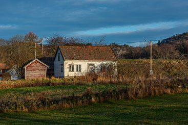Old abandoned farm in low winter sun