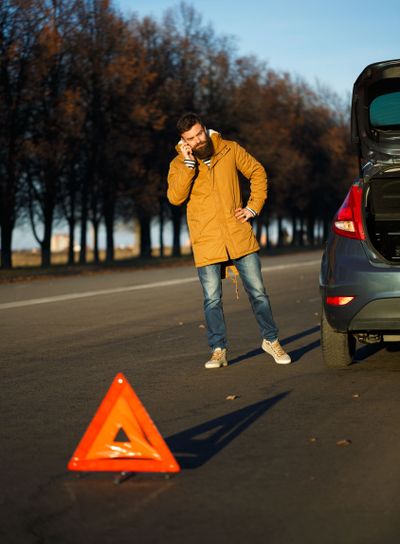 Driver man examining damaged automobile cars