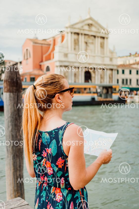 Young woman holding a map in Venice, Italy