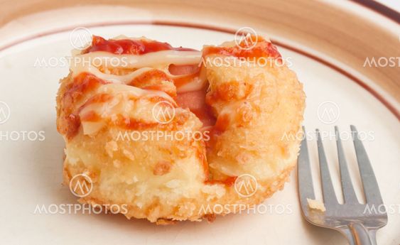 Bread stuffed with ham, topped with sauce.