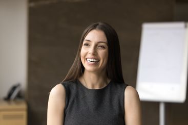 Beautiful smiling young European businesswoman posing in...
