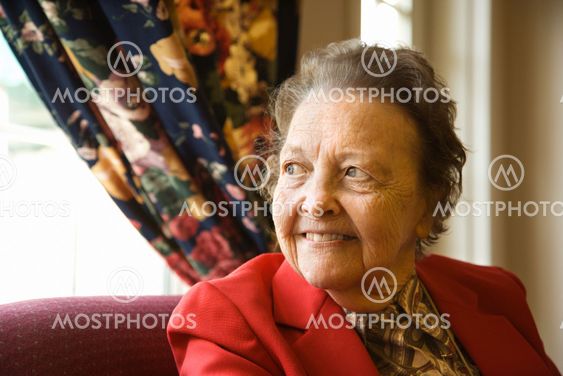 Elderly woman by window.