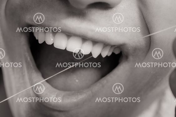 Young man cleaning her white teeth with dental floss