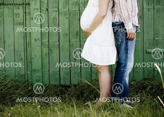 Detail of pregnant couple in nature