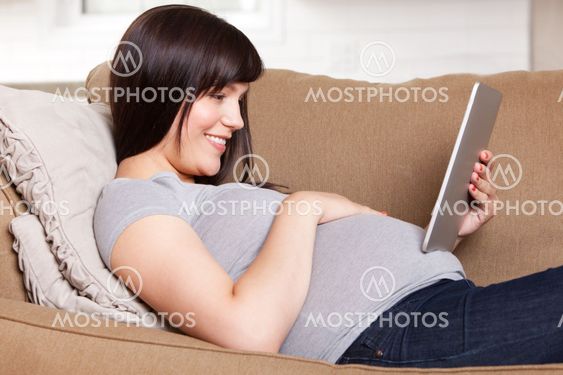 Happy Pregnant Woman with Digital Tablet