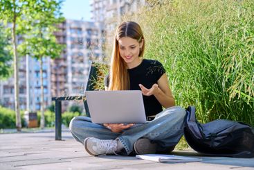 Teen female student using laptop for video chat