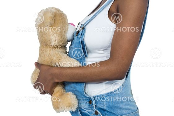 Pregnant woman holding a teddy bear