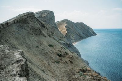 Scenic calm seashore with Crimean mountains ridge,...