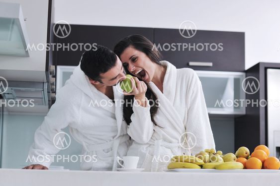 young couple have fun in modern kitchen