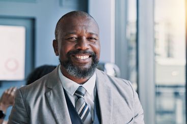 Happy, portrait and mature businessman in office with...